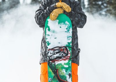Snowboarder Holding His Snowboard